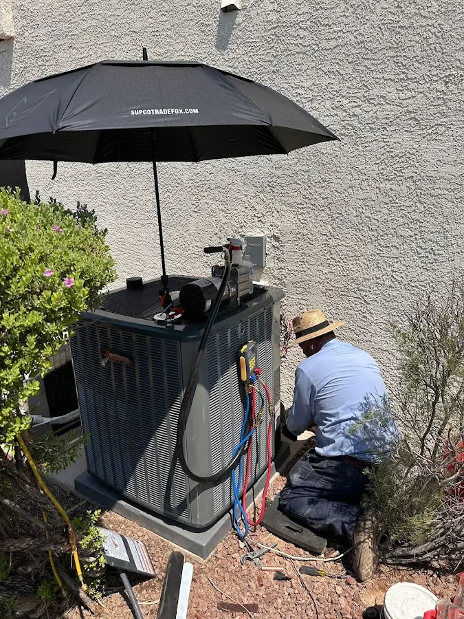 HVAC technician performing outdoor AC maintenance in Huntingdon